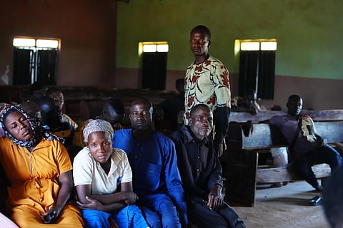 A woman and others who were kidnapped during a church service in November 2024 waves outside her house in Kaduna, northwestern Nigeria, Nov. 6, 2025.