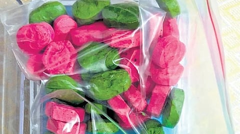 Contraband seized from 31-year-old Mathin Ahmed, including methamphetamine and colour-coded MDMA tablets.