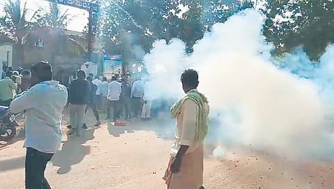 Public bursting crackers over the arrest of SI in Tekmal in Medak district on Tuesday