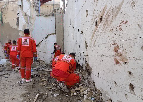 Palestinian rescue workers collect body remains at the scene where an Israeli strike on Tuesday night hit the Ein el-Hilweh Palestinian refugee camp, in the southern port city of Sidon, Lebanon, Wednesday, Nov. 19, 2025.
