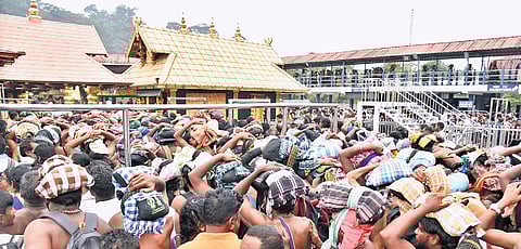 Devotees gather in huge numbers in front of the nadumuttam at Sabarimala temple for darshan on Wednesday