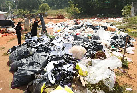 Workers stacking up all the dry waste in bags generated during the 30th CII Partnership Summit held in Visakhapatnam on November 14 and 15.  