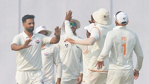 Auqib Nabi (L) celebrates a wicket with his teammates