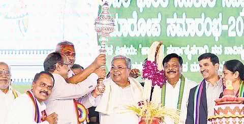 Chief Minister Siddaramaiah poses with a mace during the closing ceremony of the 72nd All-India Cooperation Week celebrations in Chamarajanagar on Thursday  | Express