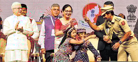 Governor Jishnu Dev Varma claps as a police officer helps children during the inauguration of the Telangana–North East Connect at HITEX in Hyderabad on Thursday.