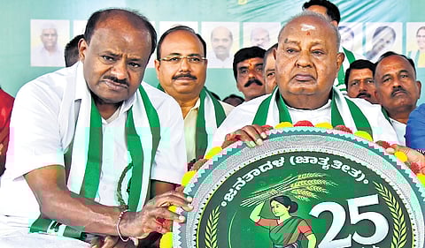 Union Minister HD Kumaraswamy with former PM HD Deve Gowda at the JDS silver jubilee celebrations in Bengaluru on Sunday.