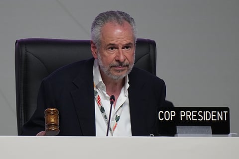 A man cleans his house at a village affected by flood in Batang Toru, North Sumatra, Indonesia, Wednesday, Dec. 3, 2025.