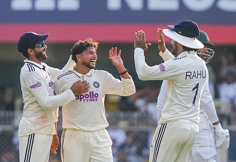 India's Kuldeep Yadav celebrates with teammates Ravindra Jadeja and KL Rahul after taking the wicket of South Africa's Wiaan Mulder during the first day of the second Test between India and South Africa at Guwahati. (Photo | PTI)