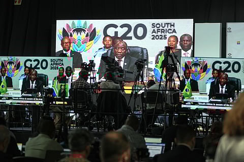 Members of the media watch on screens as South African President Cyril Ramaphosa addresses the opening session of the G20 leaders' summit, in Johannesburg, South Africa, Saturday, Nov. 22, 2025. 