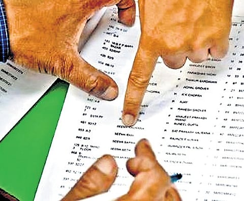 A Booth Level Officer (BLO) interacts with a resident during the house-to-house distribution of Enumeration Forms (EFs) for the second phase of the Special Intensive Revision (SIR) of electoral rolls at Baghajatin in Kolkata.