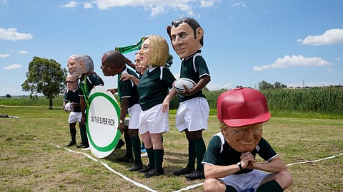 Demonstrators wearing big heads of world leaders protest in Soweto during the opening session of the G20 leaders' summit in Johannesburg.