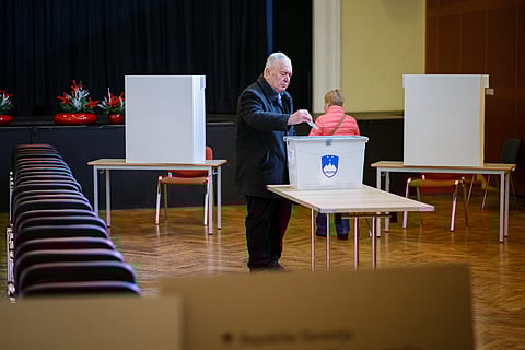 A voter casts his ballot for a referendum that will determine if a law legalising assisted dying will be enforced or suspended at a polling station in Radomlje, on November 23, 2025. 