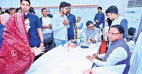 Bidyutprava Sarangi, a resident of Jayadev Vihar, speaks to CM Mohan Charan Majhi during the grievance hearing, in Bhubaneswar on Monday| express 