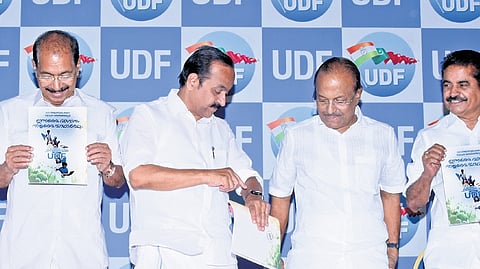 As Sunny Joseph and Adoor Prakash pose with a copy of the UDF manifesto, 
V D Satheesan points at his watch indicating to P K Kunhalikutty that it was time to leave for the next event, in Kochi on Monday 