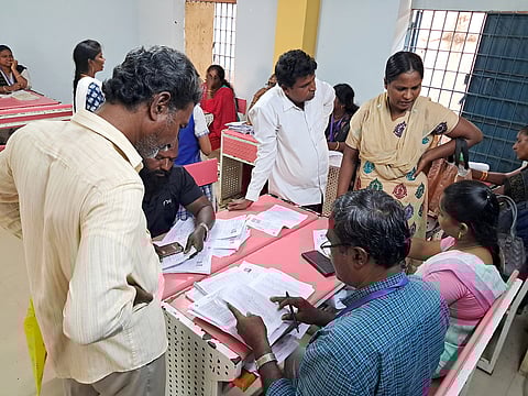People filling up enumeration forms at SIR help desk in Vyasarpadi.