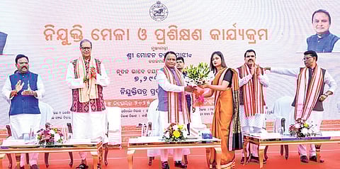 Chief Minister Mohan Charan Majhi handing over appointment letter to a newly- recruited candidate, in Bhubaneswar on Tuesday 