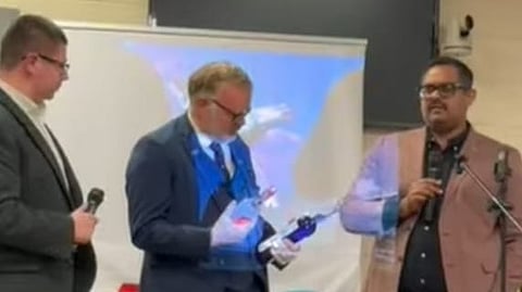 Scotland first minister John Swinney, Manavatty arrack founder John Xavier, and Socialist National Party candidate Martyn Day with bottles of 'Manavatty' arrack.