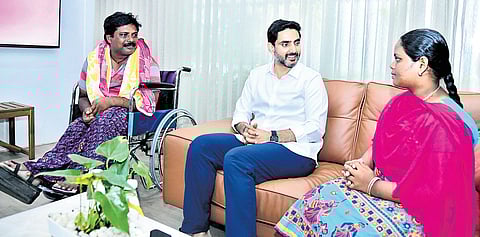 HRD Minister Nara Lokesh interacts with Kurmala Sri Kanakaputlamma, who has been selected for the Mock Assembly, on Tuesday