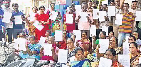 Sanitary workers from Royapuram and Thiru-Vi-Ka Nagar zones submitting petitions to the respective zonal official on Wednesday, urging the GCC to reinstate them in their job 