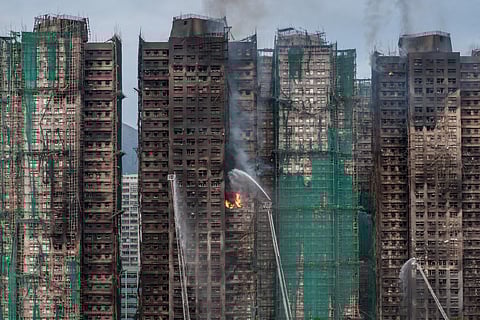 Smoke rises from apartments after a major fire swept through several blocks at the Wang Fuk Court residential estate in Hong Kong's Tai Po district.