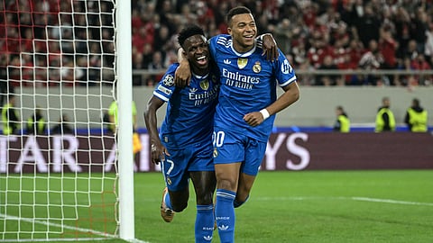 Real Madrid's Kylian Mbappe (R) celebrates with Vinicius Junior (L) after scoring Real Madrid's fourth goal during the UEFA Champions League, league phase - matchday 5, football match between Olympiakos and Real Madrid on November 26, 2025.
