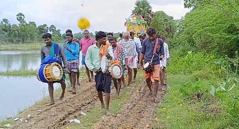 The residents of Vellapakkam carrying a funeral on the slushy narrow path to the village cremation ground.