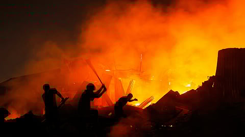 Rescuers try to douse a major fire that engulfed Korail Slum in Dhaka, Bangladesh, Tuesday, Nov. 25, 2025.