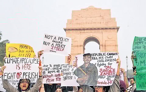 People raise slogans during a protest against worsening air quality in the capital, at India Gate.