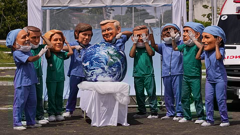 Demonstrators with the likeness of world leaders including President Donald Trump, center, pretend to drill into the Earth during the COP30 U.N. Climate Summit, Thursday, Nov. 20, 2025, in Belem, Brazil. 