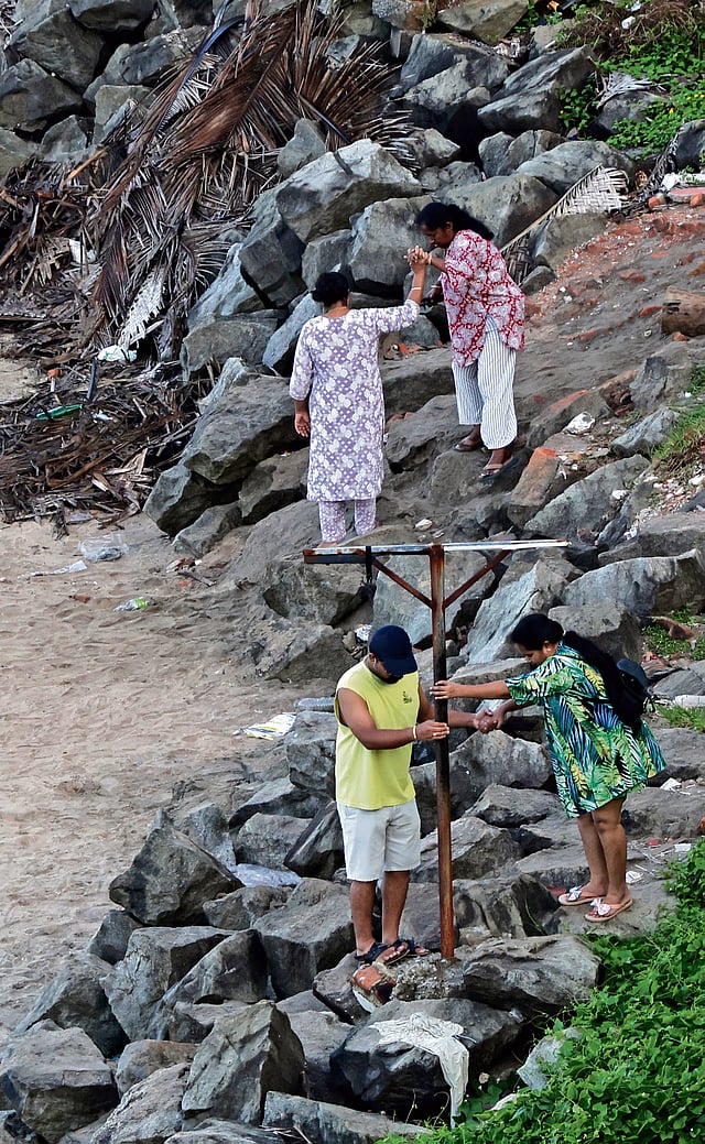 Tourist struggle their way down a rocky path