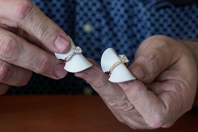 Ian Furman, a jewelry consultant, points out the difference between real (at right) and synthetic diamonds used on engagement and wedding rings in Johannesburg, South Africa, Thursday, Nov. 13, 2025.