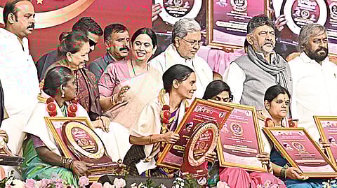 Chief Minister Siddaramaiah, DCM DK Shivakumar, ministers Laxmi Hebbalkar and Eshwar Khandre after felicitating Anganawadi workers during the golden jubilee celebrations of the ICDS programme in Bengaluru on Friday.
