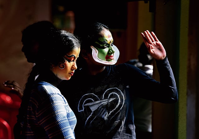 Two Kathakali contestants hang around after their performance to enjoy the show