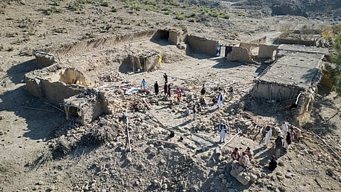 Afghan men search through the rubble at the site of an overnight attack on a home that, according to an Afghan government spokesman, was carried out by Pakistan in the Gurbaz district of Khost province, Afghanistan, Tuesday, Nov. 25, 2025.