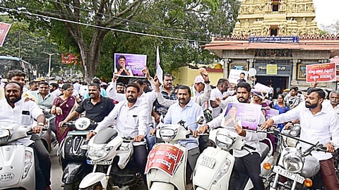 Vokkaligas take out a bike rally in support of DCM D K Shivakumar in Mysuru on Saturday.