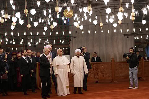 Pope Leo XIV and Ecumenical Patriarch Bartholomew I, the spiritual leader of the world's Eastern Orthodox Christians, leave after attending the Doxology at the Patriarchal Church of Saint George, in Istanbul, Turkey, Saturday, Nov. 29, 2025.