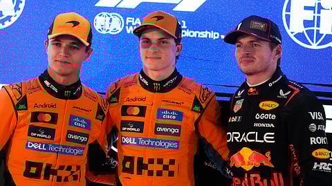 McLaren's Oscar Piastri (C) is flanked by Mclaren's Lando Norris (L), and Red Bull driver Max Verstappen after the second qualifying session at the Lusail International Circuit ahead of the Qatar Formula One Grand Prix, in Lusail, Qatar, Saturday, Nov. 29, 2025.