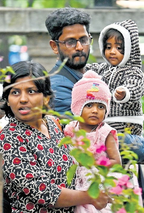 Children covered head to toe in warm clothes venture out with 
their parents