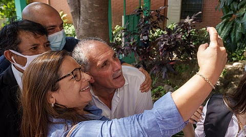 National Party presidential candidate Nasry Asfura poses for a selfie with a supporter after voting at a polling station in the general elections in Tegucigalpa, Honduras, Nov. 28, 2021.