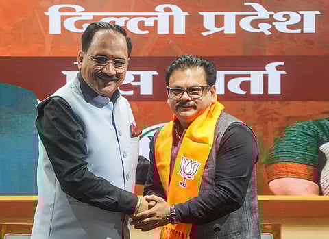 Delhi BJP president Virendra Sachdeva welcomes Gupta into his party