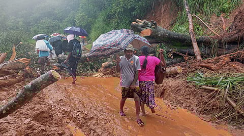 Rescuers recover the body of a flood victim in Padang Panjang, West Sumatra, Indonesia, Monday, Dec. 1, 2025. 