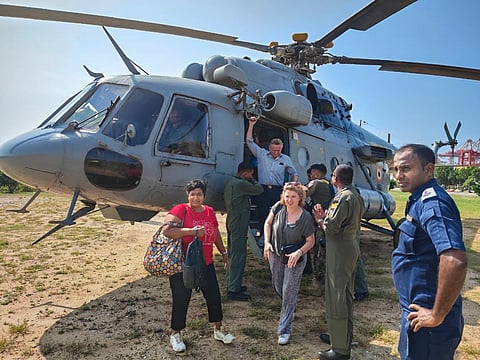 Landslide survivors cross a section of a road that is blocked by debris in Hanguranketha, Sri Lanka, Saturday, Nov. 29, 2025