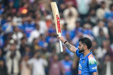 India's Virat Kohli celebrates after scoring a century (100 runs) during the first ODI cricket match between India and South Africa at the JSCA International Stadium in Ranchi on November 30, 2025.