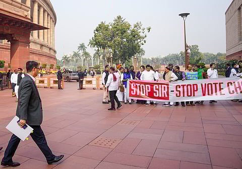Union Minister Kiren Rijiju, left, arrives as oppostion leaders protest against Special Intensive Revision (SIR) at Parliament complex during Winter session, in New Delhi, Tuesday, Dec. 2, 2025.