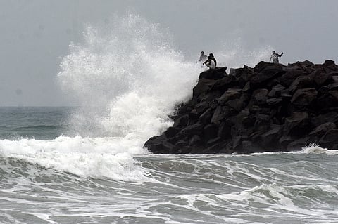 Police stand guard on NH4, preventing the public from entering. Shots show the impact of Cyclone Ditwah at Ennore and Kasimedu. 