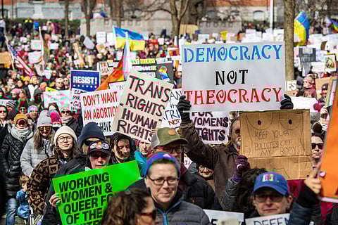 Demonstrators rally on Boston Common on International Women's Day in Boston, Massachusetts, on March 8, 2025. 