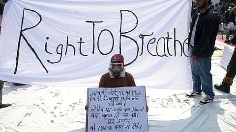Demonstrator wearing an oxygen mask protests demanding government's action to reduce air pollution in New Delhi.