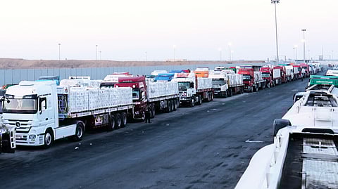 Trucks carrying humanitarian aid prepare to cross the Egyptian gate of the Rafah crossing, waiting for inspections by Israeli authorities before entering the Gaza Strip, following an agreement between Israel and Hamas on a ceasefire, Oct. 20, 2025.