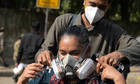 Demonstrator wearing an oxygen mask protests demanding government's action to reduce air pollution in New Delhi.