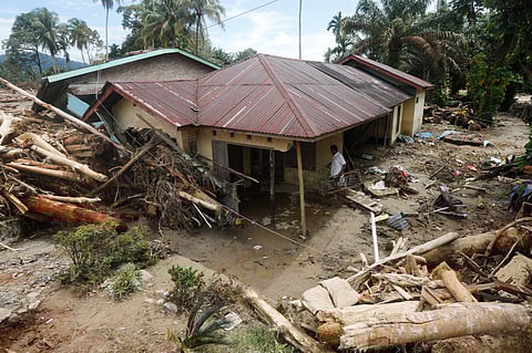 People use a crude raft to navigate a flooded street in Colombo, Sri Lanka, Saturday, Nov. 29, 2025.